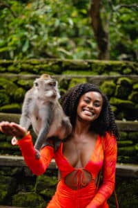 A Solo female traveler with a monkey in the jungle